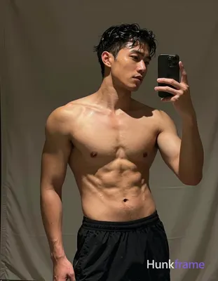 Asian man with short dark black slightly wavy wet-looking hair parted left, clean-shaven face neutra