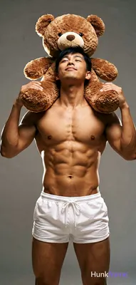 Asian man with medium-tan skin, black short hair with side-swept bangs, and clean-shaven face. Stand