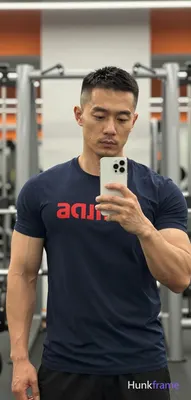 Asian man with medium-tan skin and short buzz cut, textured fade on sides and ba