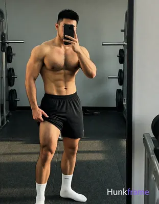 Asian man with light-medium skin and black short textured crop hair, clean-shaven jawline standing i