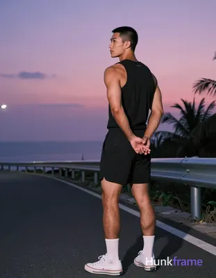 Asian man with medium-tan skin and short black buzz cut, clean-shaven face, neutral contemplative ga