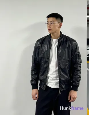 Asian man with short black flat-top hair under cap, rimless thin metal frame gla