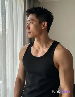 Asian man with medium-tan skin and short textured black hair, standing casually in a home setting ne