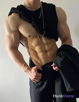 torso angled left; He is shirtless with pectorals fully exposed and defined abs 