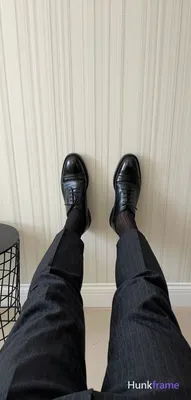 Full-bleed vertical wallpaper composition of an adult man seated with legs exten