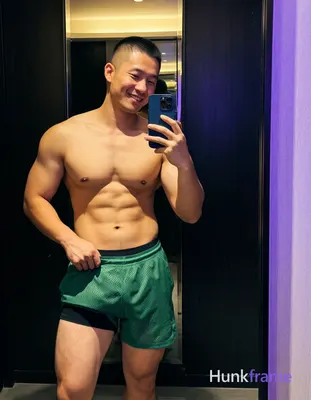 Asian man with short buzz cut and clean-shaven face smiling relaxed in a tastefu