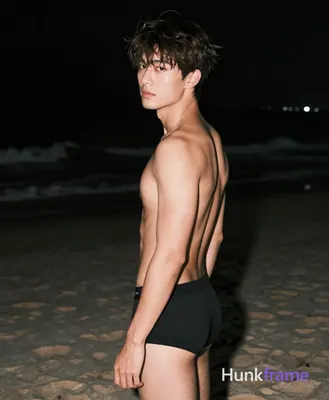Asian man with short dark brown tousled hair and side-swept bangs, clean-shaven face, neutral seriou