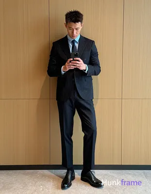 Asian man with light to medium tan skin and short textured dark hair, clean-shaven face wearing a fo