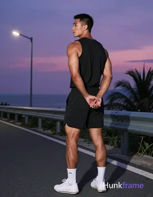 Asian man with medium-tan skin and short black buzz cut, clean-shaven face, neutral contemplative ga