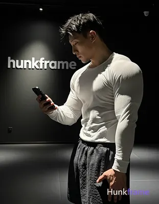 Asian man with short spiky black hair and faded undercut, clean-shaven chin with light upper lip stu