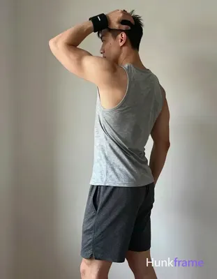 A handsome masculine man in a premium fashion editorial, standing in profile wit