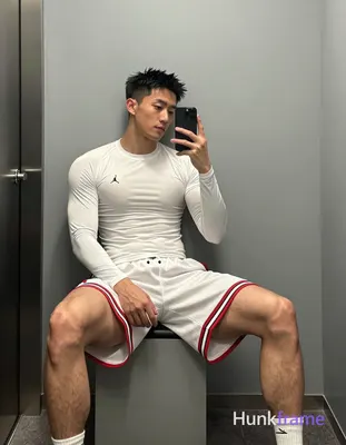 Asian man with light-medium skin and short black textured spiky hair, clean-shaven face in mirror se