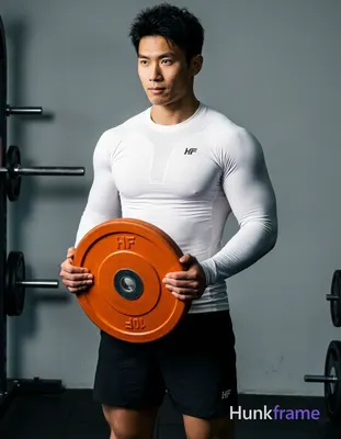 Asian man with light-medium skin, short black textured hair and clean-shaven face in a gym setting; 