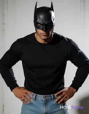 Adult man with light medium tan skin and light stubble on chin, wearing black Batman-style cowl mask