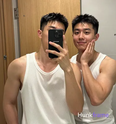 an anonymous figure men in a mirror selfie composition, left side of frame dominated by subject one 