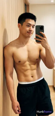 Asian muscular man with short black hair and clean-shaven face stands in a fresh lifestyle pose lean