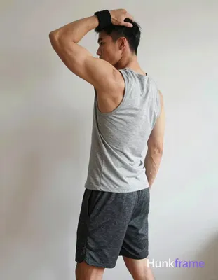 A handsome masculine man in a premium fashion editorial, standing in profile wit