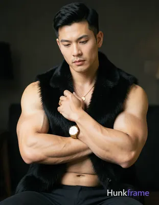 shirtless man with muscular build, arms crossed over chest, hand resting on fur 