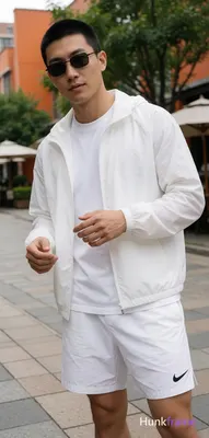 Asian man with short black buzz cut and rectangular thin black framed sunglasses
