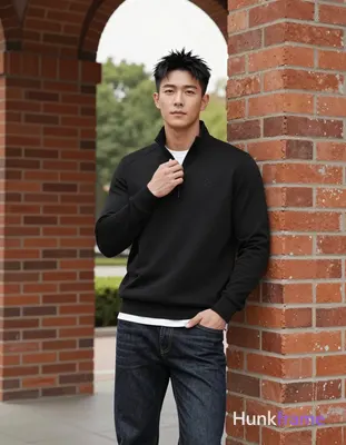 Asian man, light-medium skin, short textured black hair styled upward at the crown with tapered side