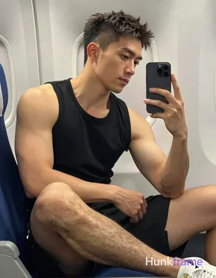 Asian man with light to medium tan skin and short dark brown hair featuring a textured top with fade