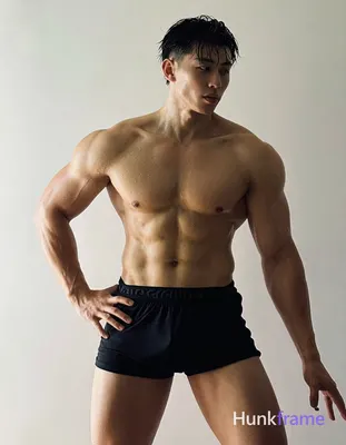 Asian man with light to medium tan skin glistening from water droplets He is shi