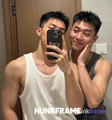 an anonymous figure men in a mirror selfie composition, left side of frame dominated by subject one 