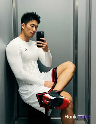 Asian man with light-medium skin and short black textured spiky hair, clean-shaven face in mirror se