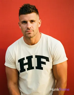 an anonymous figure man with short spiky dark brown hair fading to a tight buzz,