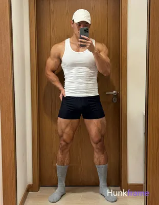Candid iPhone selfie of a handsome muscular man with light-medium skin and short dark hair under a w