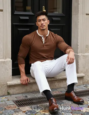 Asian man with light-medium skin and short dark brown undercut hair sits centere