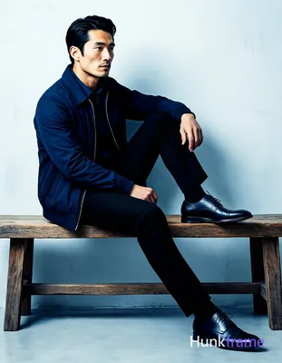 Bold flat-color wall art graphic of an Asian man with fair skin and black short hair styled back sit