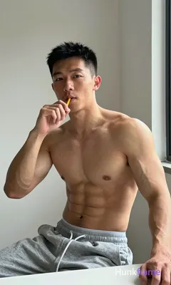 Asian adult man with short dark black hair and clean-shaven face, shirtless uppe