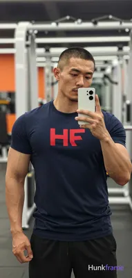 Asian man with medium-tan skin and short buzz cut, light stubble on jawline hold
