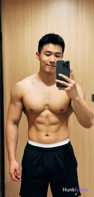 Asian muscular man with short black hair and clean-shaven face stands centered i
