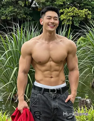Asian adult man with short black buzz cut and clean-shaven face, smiling broadly
