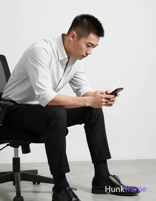 Asian man with short buzz cut, dark brown/black textured top fade to skin on sides and back, clean-s