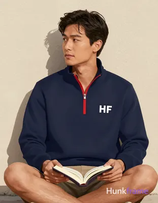 Asian man with medium-tan skin, dark wavy hair side-swept across forehead, clean-shaven face holding