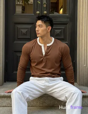 Asian man with short black textured spiky hair fading to tight buzz, clean-shaven face, neutral cont