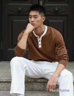 Asian man with short black textured spiky hair fading to tight buzz, clean-shaven face, neutral cont