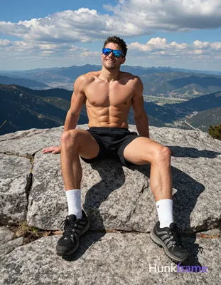 Seated on large granite rock outcrop with torso upright leaning back slightly against hands placed f