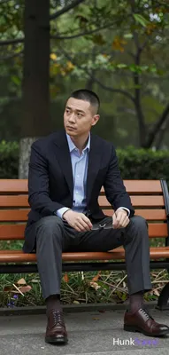 Asian man short buzz cut dark brown black uniform length sides top clean-shaven neutral contemplativ
