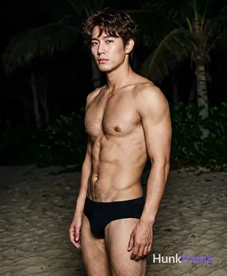 Asian man with short dark brown tousled hair and side-swept bangs, clean-shaven face, neutral seriou