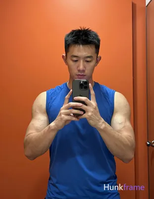 Asian man with light-medium skin and short black hair standing in a modern bathr