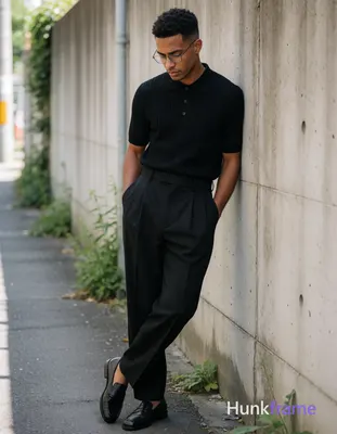 A handsome adult man with medium-dark skin and short dark hair featuring a textu