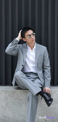 Asian man in a light gray suit jacket, notched lapel, single-button closure with