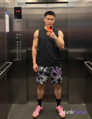 Asian man with medium-dark skin and short black straight hair stands in a full-b