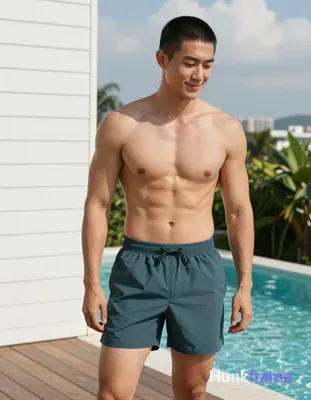 Asian man with short black buzz cut and clean-shaven face, light tan skin smiling gently while looki