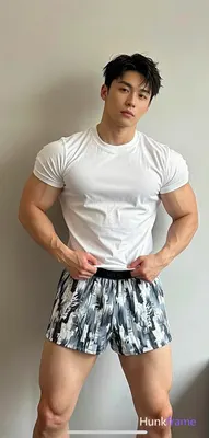 Asian adult man with short dark tousled hair parted left and clean-shaven face, neutral serious expr