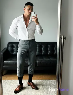 Asian man standing in front of full-length mirror holding white smartphone at ch
